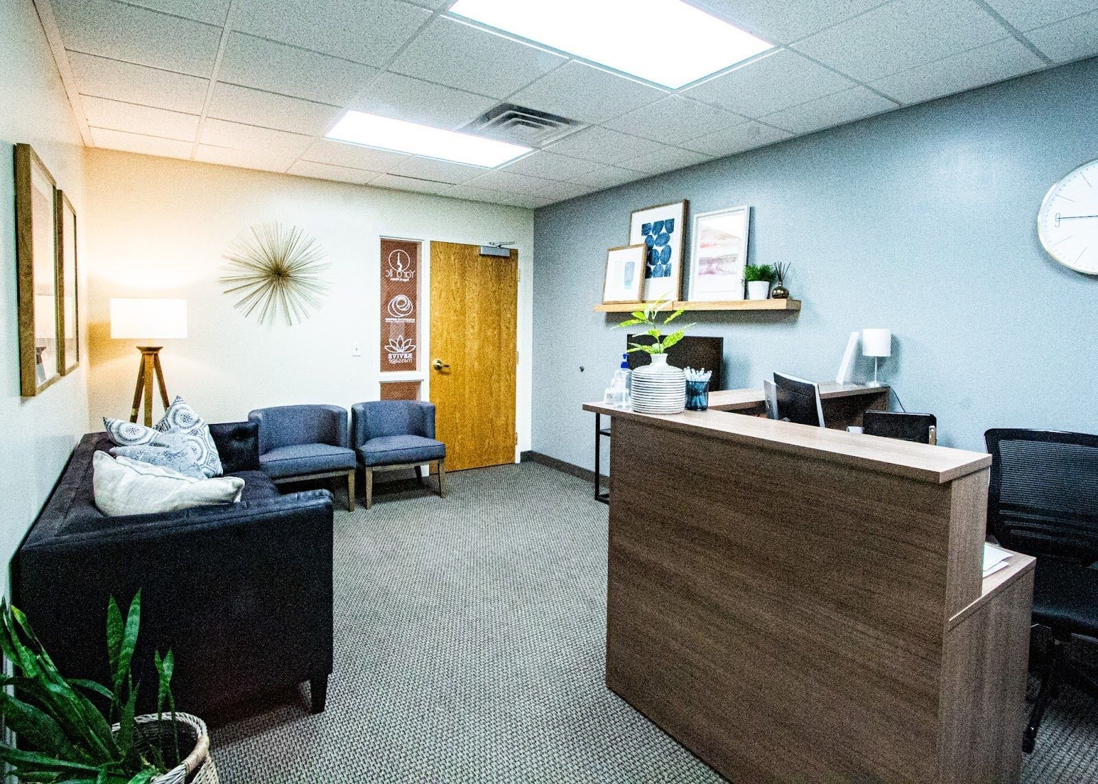 Revive Massage waiting room with couch, chairs, and reception desk