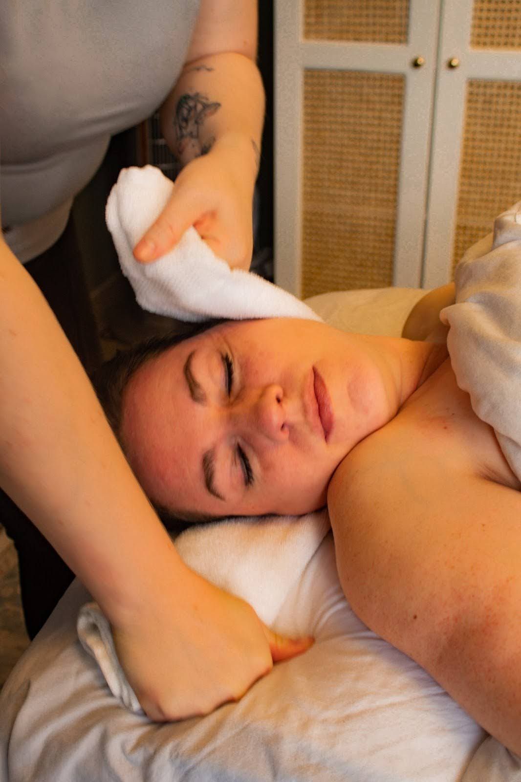 Therapist using a towel technique on a client's head and neck