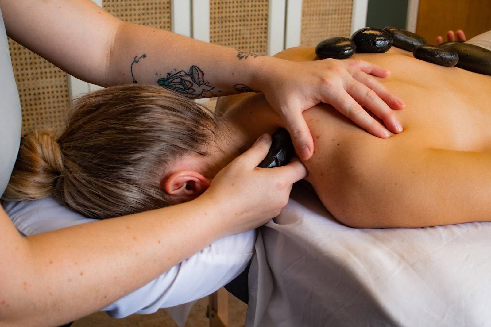 Hot stones placed along a client's back during a hot stone massage