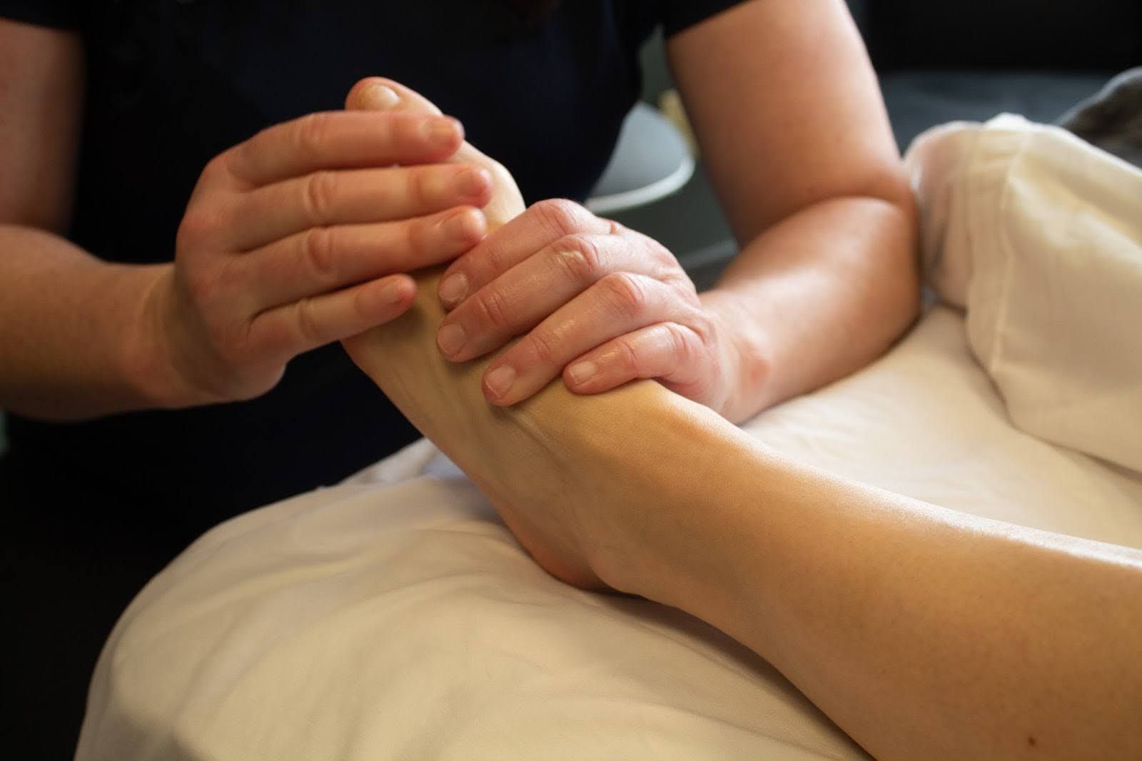 Therapist working on a client's foot during a therapeutic massage