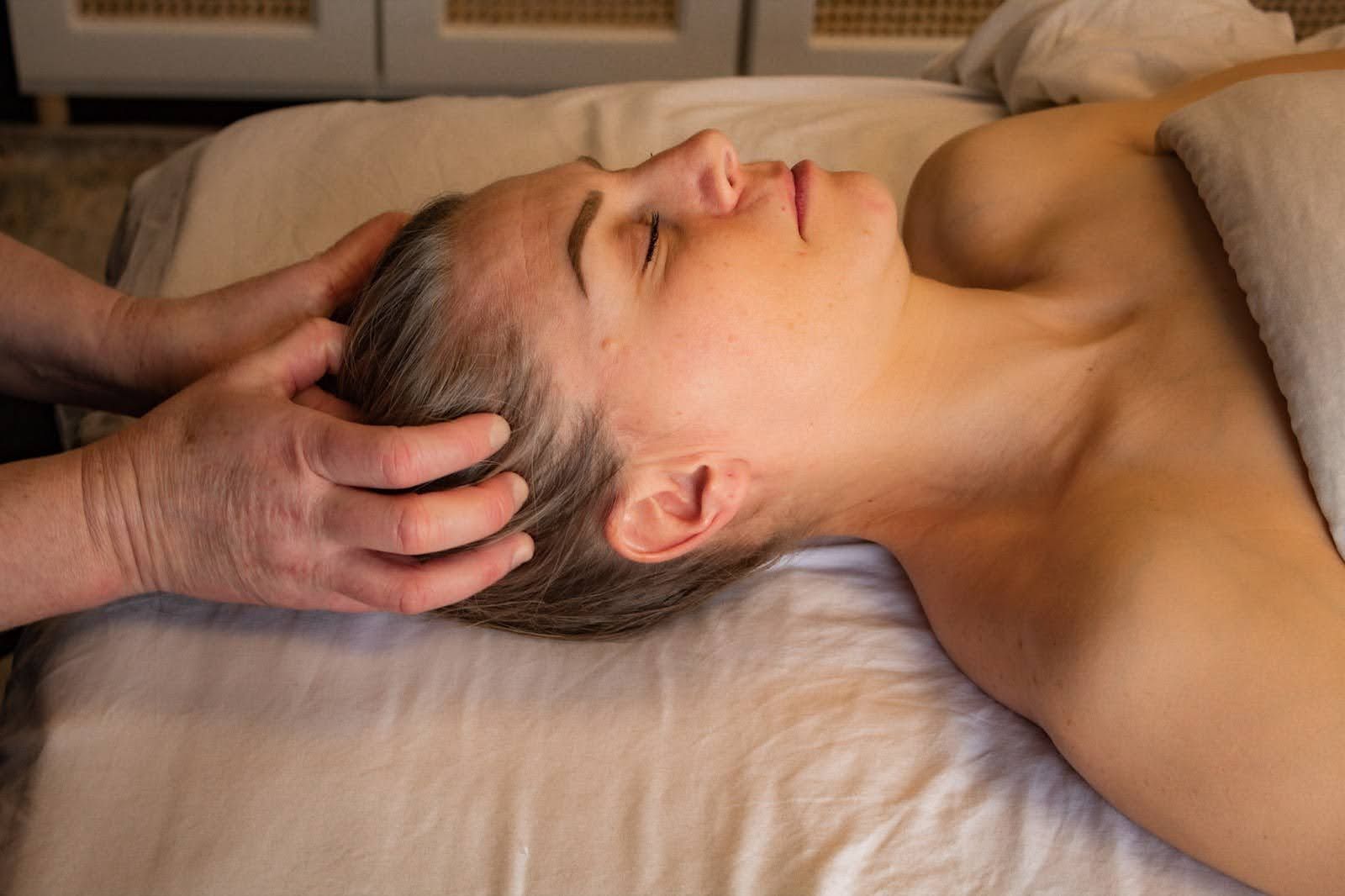 Client receiving a relaxing scalp massage